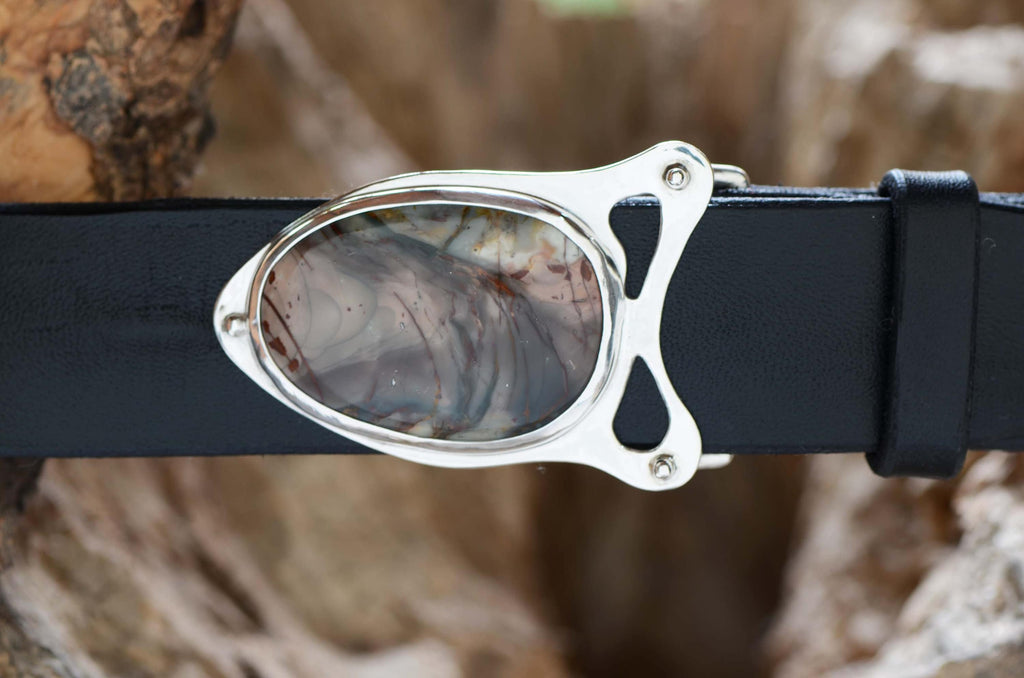 Gray-and-red morrisonite jasper stone in silver belt buckle setting. Shown with black leather belt.